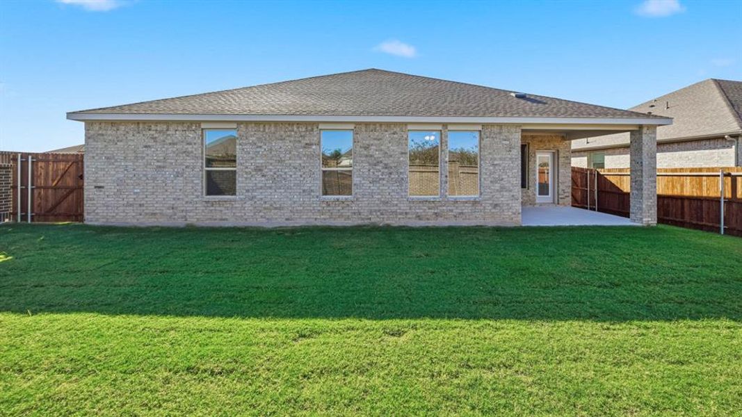Back of property featuring brick siding, a patio area, and roof with shingles Back of property featuring brick siding, a patio area, and roof with shingles