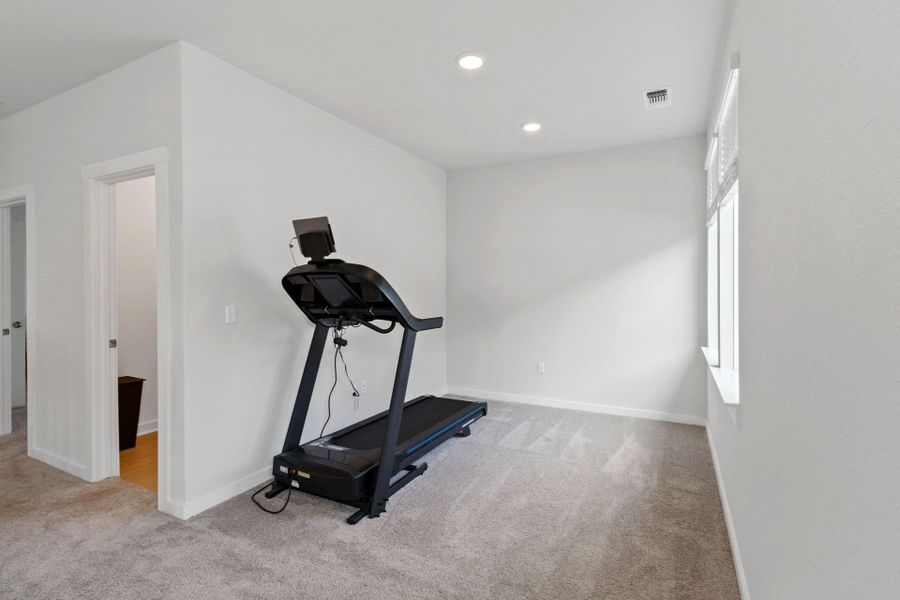 Loft/Workout room with recessed lighting