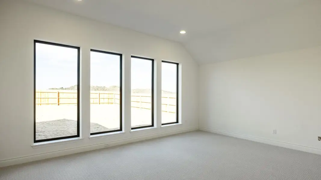 Empty room featuring recessed lighting, light carpet, vaulted ceiling, and baseboards