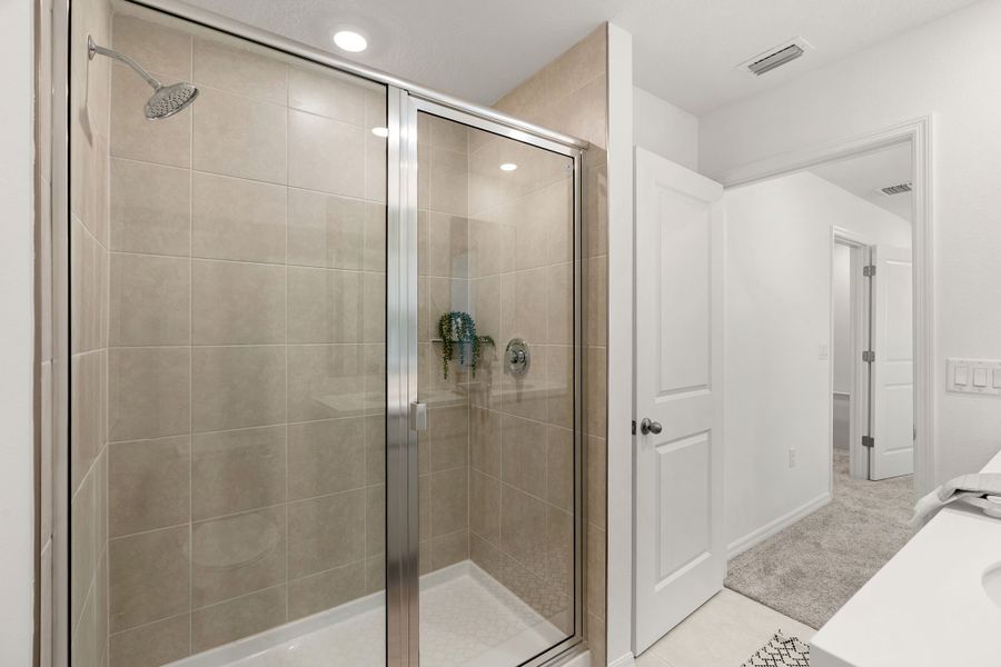 Shower Enclosure and Floor to Ceiling Tile in Primary Bath