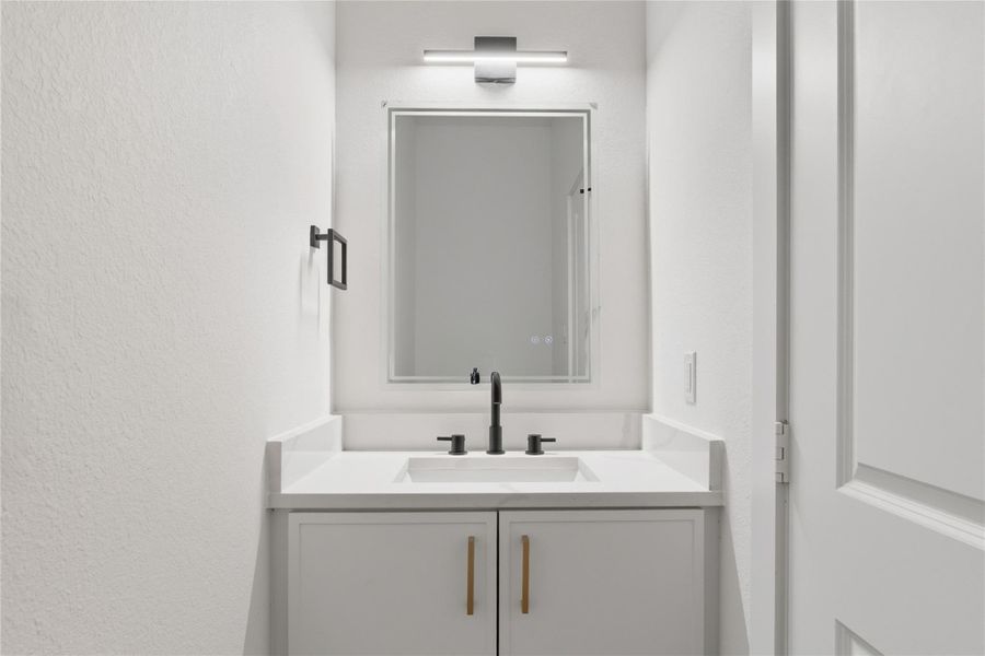 The guest bath is simple yet stylish, featuring modern finishes with sleek vanities, quartz countertops, and matte black fixtures that add the perfect touch of sophistication.