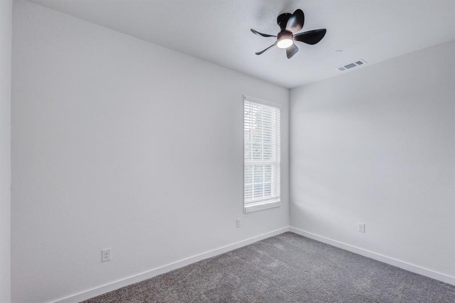 Unfurnished room featuring carpet floors and ceiling fan