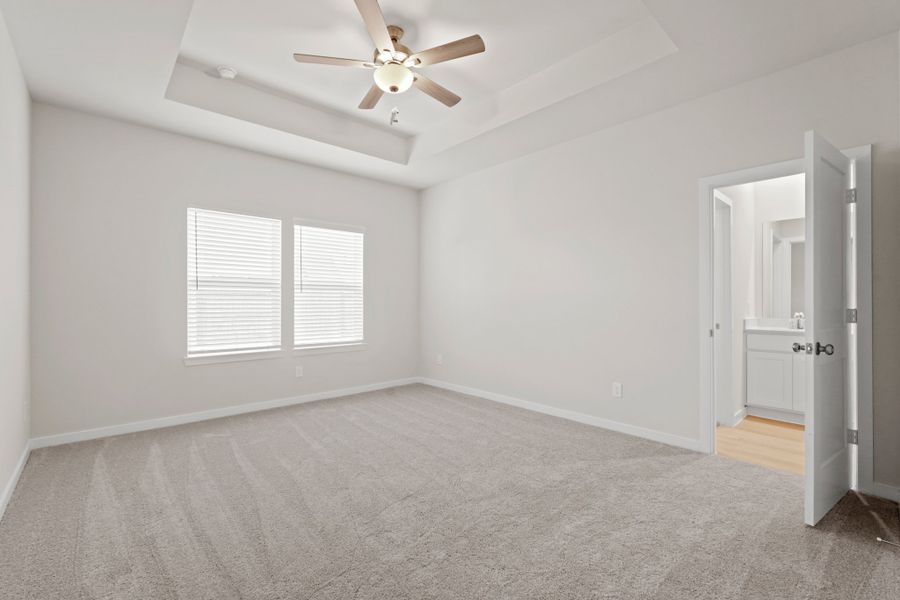 A room with a ceiling fan and a door. A room with a ceiling fan and a door.