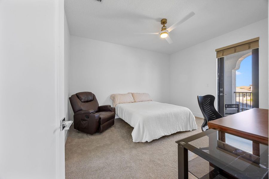 Bedroom featuring access to exterior, light carpet, and ceiling fan