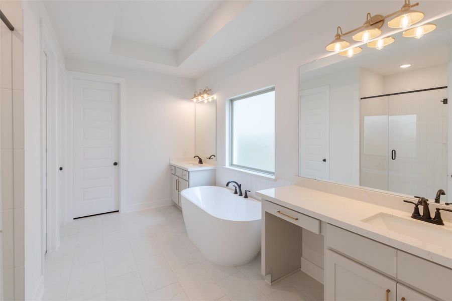 Freestanding bathtub, dual sinks, and a spacious glass-enclosed shower