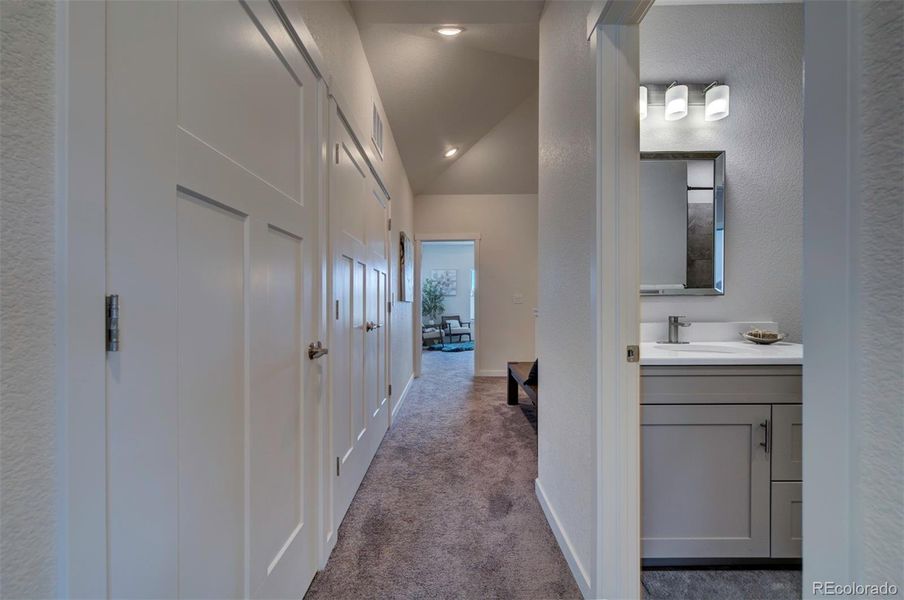 Upstairs hallway looking towards the primary bedroom and stairs.