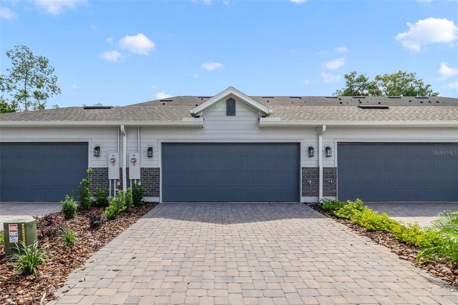Front exterior of a new home in Aulin Square, Oviedo, FL, highlighting curb appeal (Image 2). Front exterior of a new home in Aulin Square, Oviedo, FL, highlighting curb appeal (Image 2).