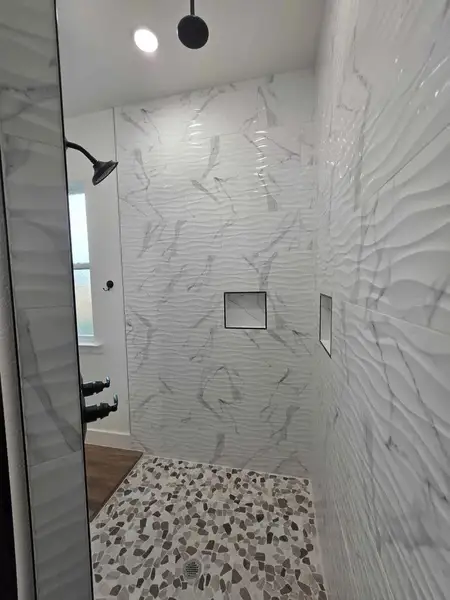 Full bath featuring a marble finish shower and recessed lighting Full bath featuring a marble finish shower and recessed lighting