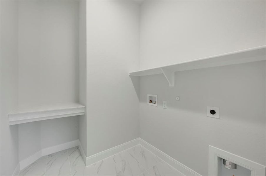 Laundry area featuring hookup for a gas dryer, hookup for a washing machine, hookup for an electric dryer, and light marble finish floors