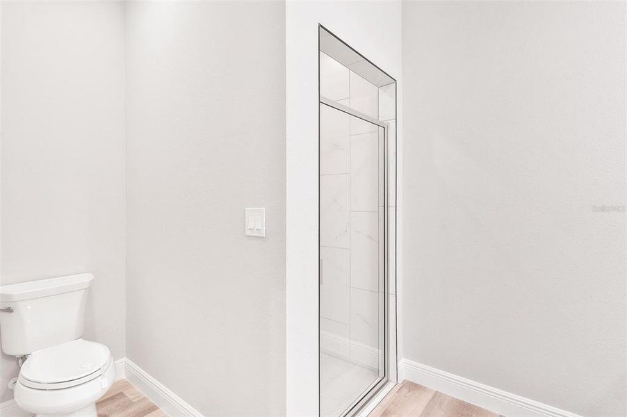 Primary Bathroom with Walk-in Shower and Private Closet