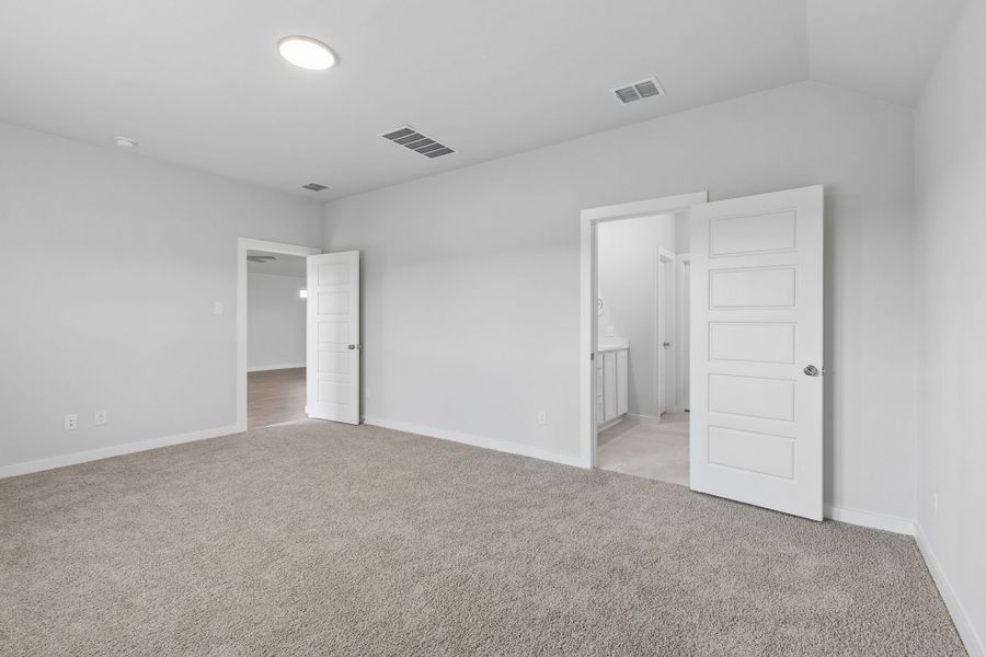 Primary Suite in the Oscar home plan by Trophy Signature Homes – REPRESENTATIVE PHOTO