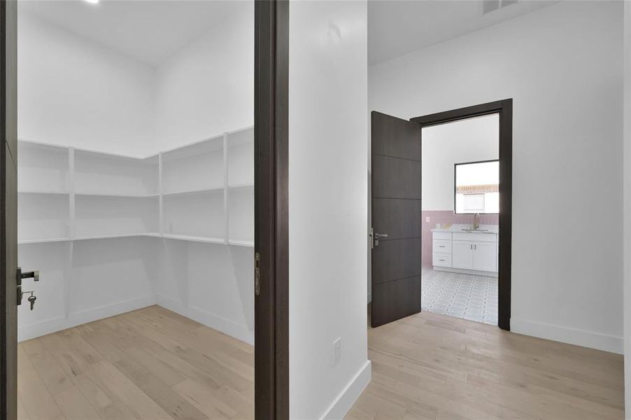 Expansive walk-in pantry conveniently located at the kitchen's rear.