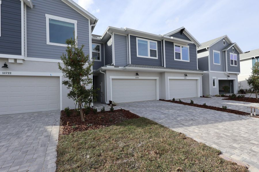 Front exterior of a new home in North River Ranch – Townhomes, Parrish, FL, highlighting curb appeal (Image 1). Front exterior of a new home in North River Ranch – Townhomes, Parrish, FL, highlighting curb appeal (Image 1).
