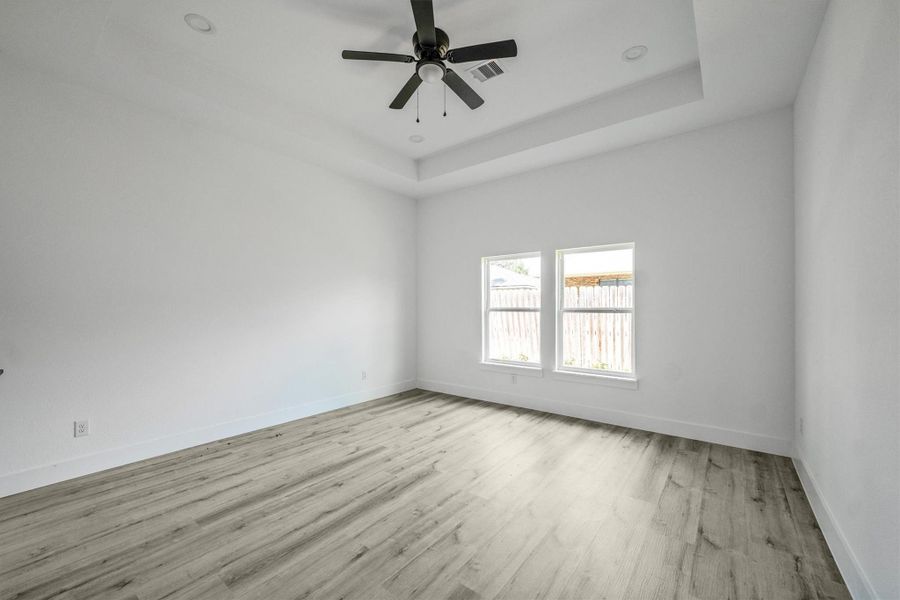 Master bedroom features an incandescent ceiling with recessed lighting giving it perfect blend of functionality and aesthetic