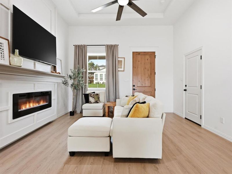 This living room with coffered ceilings and natural light is welcoming to all!