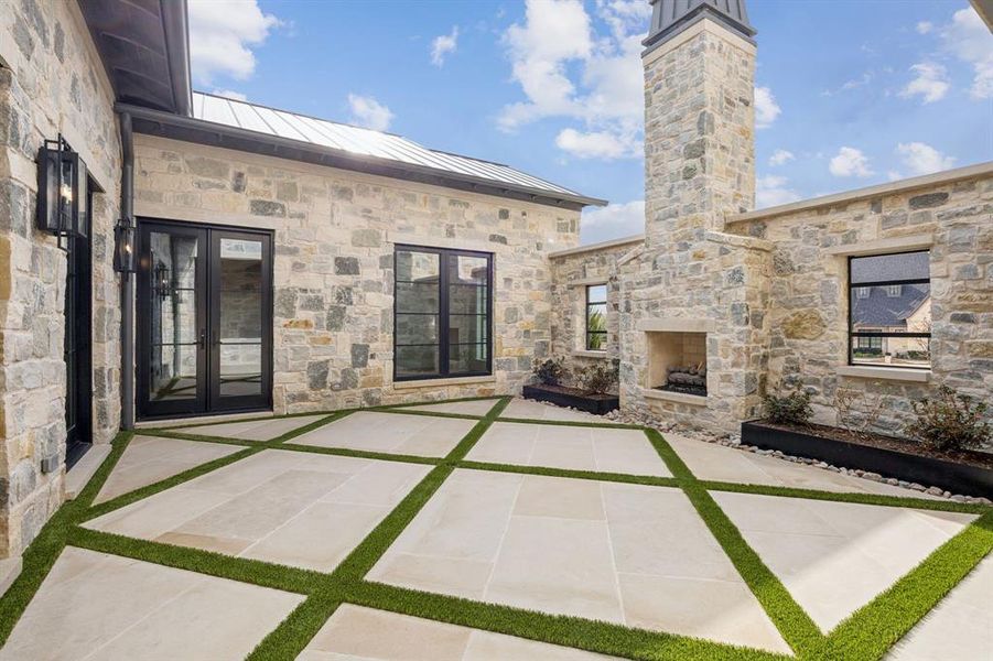 Private courtyard entrance behind the frosted iron double doors