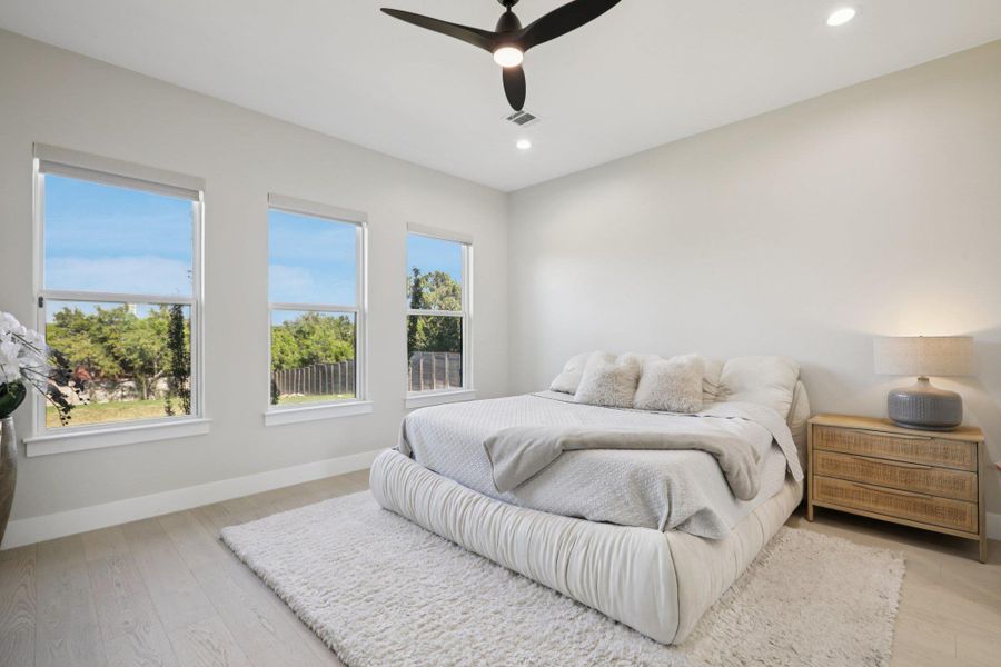 Bedroom featuring light wood-style flooring, ceiling fan, and recessed lighting