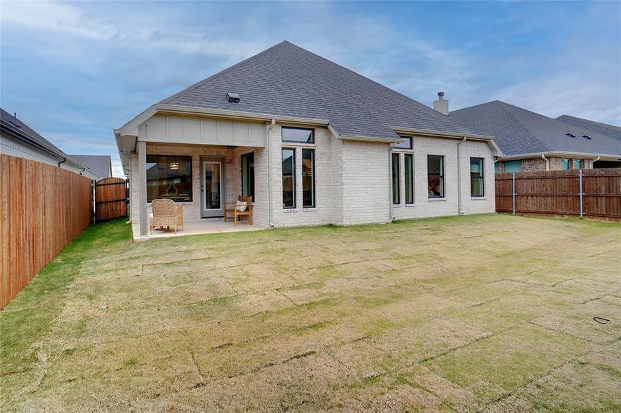 Back of house featuring a patio area and a yard