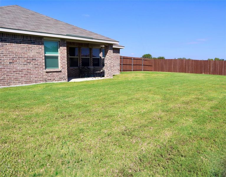 Fenced backyard featuring a patio Fenced backyard featuring a patio