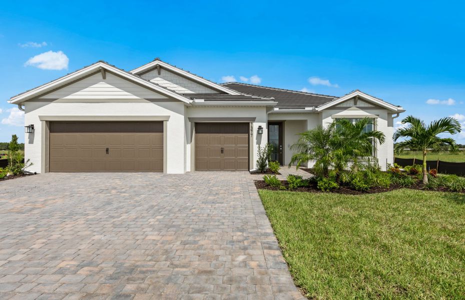 Front exterior of a new home in Del Webb Oak Creek, North Fort Myers, FL, highlighting curb appeal (Image 16).