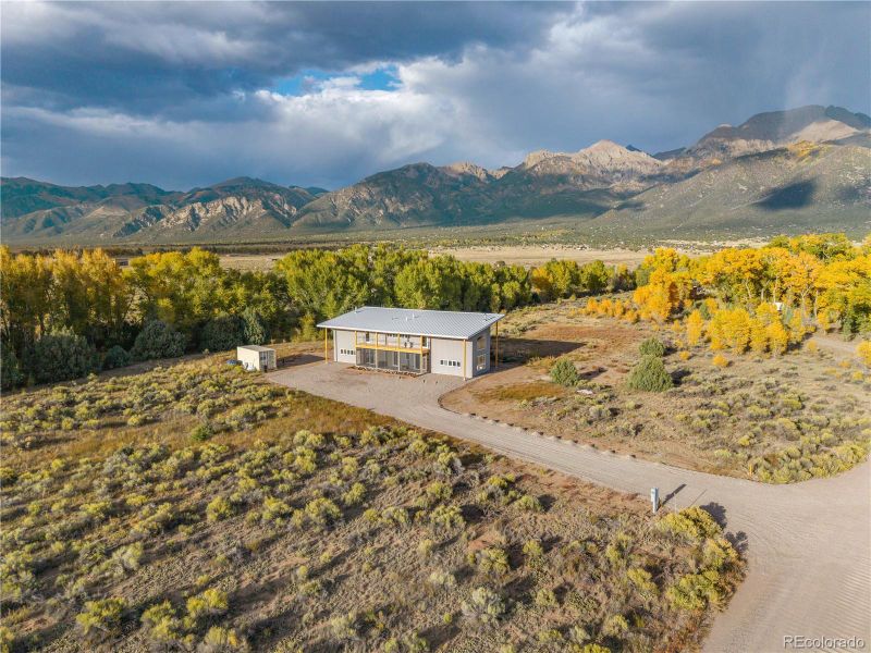 Arial shot of house and surrounding mountain views.