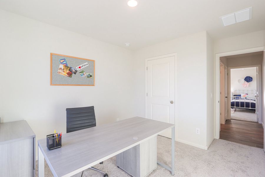 A room with a table and a door.