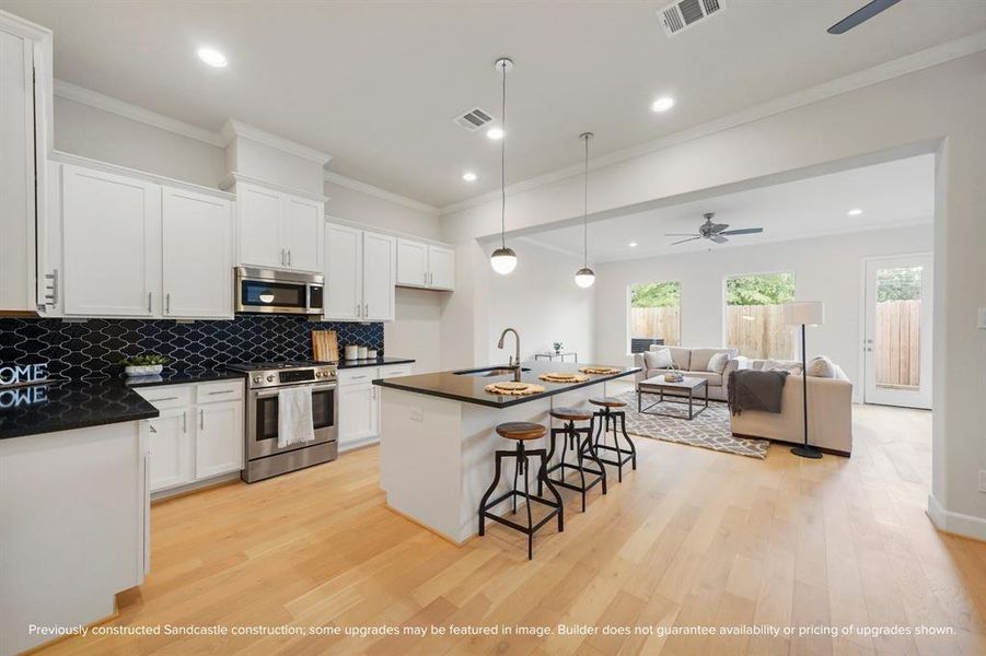 Pre-wired for pendant lights, the kitchen island adds a touch of elegance to your culinary space.