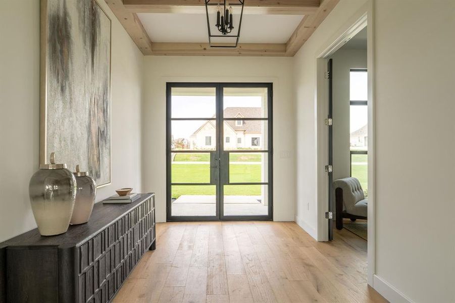 Entryway with wood finished floors and french doors Entryway with wood finished floors and french doors