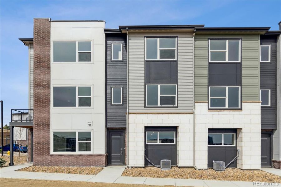 Front exterior of a new home in Townhome Collection at Grand Vue at Interlocken, Broomfield, CO, highlighting curb appeal (Image 1).