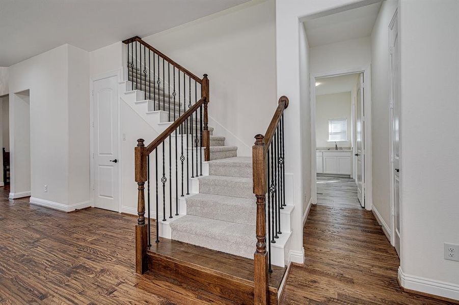 Stairway featuring hardwood / wood-style floors