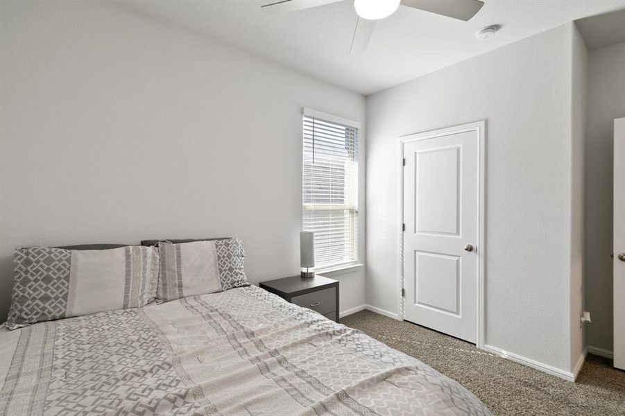 Bedroom featuring dark carpet and ceiling fan