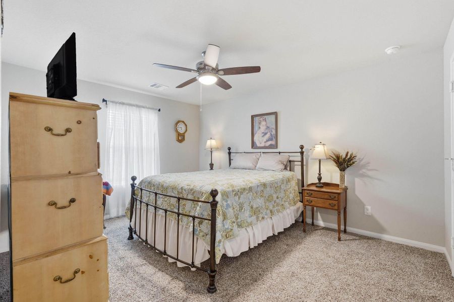 Another large secondary bedroom with ceiling fan and closet