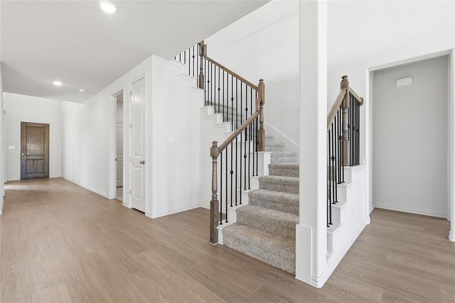 Staircase featuring wood finished floors and recessed lighting Staircase featuring wood finished floors and recessed lighting