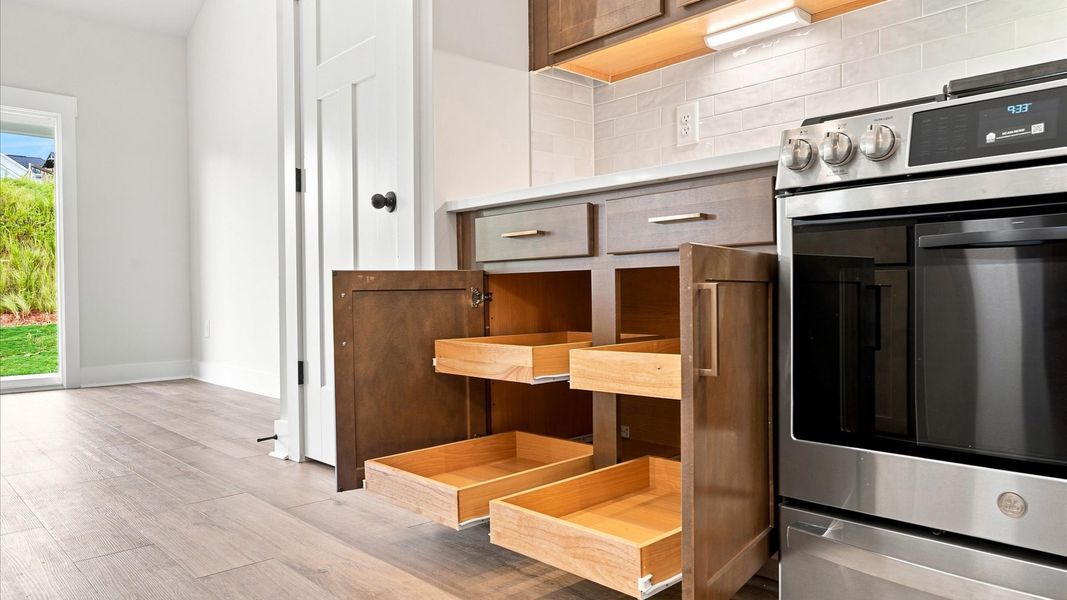 Expansive kitchen offering exceptional storage space and effortless flow to adjacent living areas by DRB Homes