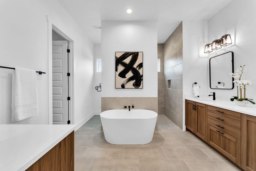 Luxurious bathroom features a spacious soaking tub, walk-in shower, and ample vanity space with modern fixtures. Luxurious bathroom features a spacious soaking tub, walk-in shower, and ample vanity space with modern fixtures.