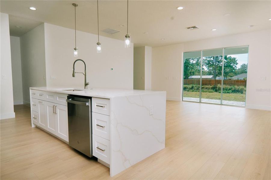 Kitchen with a full quartz waterfall island