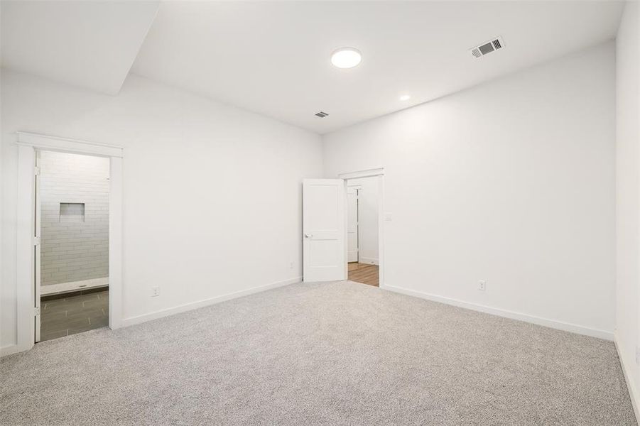 Unfurnished bedroom featuring carpet, visible vents, and baseboards