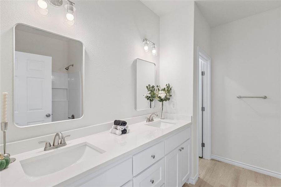 Bathroom with double vanity and light wood-style floors Bathroom with double vanity and light wood-style floors