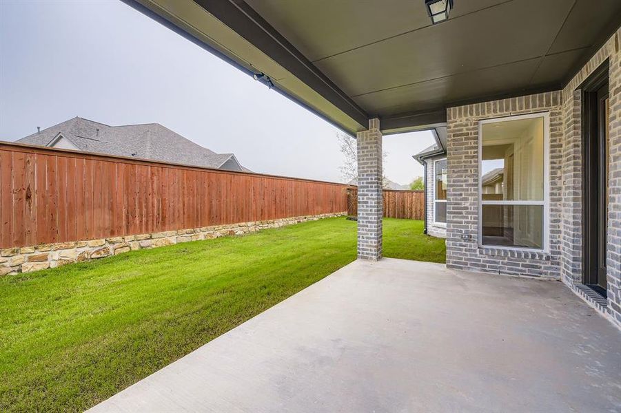 Fenced backyard with a patio area
