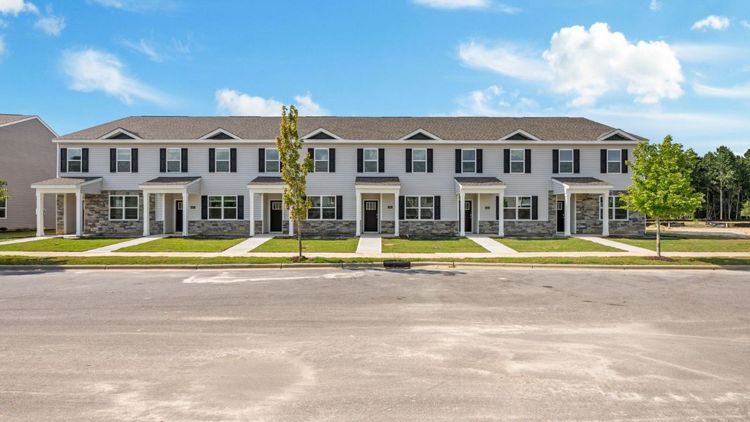 Front exterior of a new home in Clock Road Townhomes, New Bern, NC, highlighting curb appeal (Image 1).