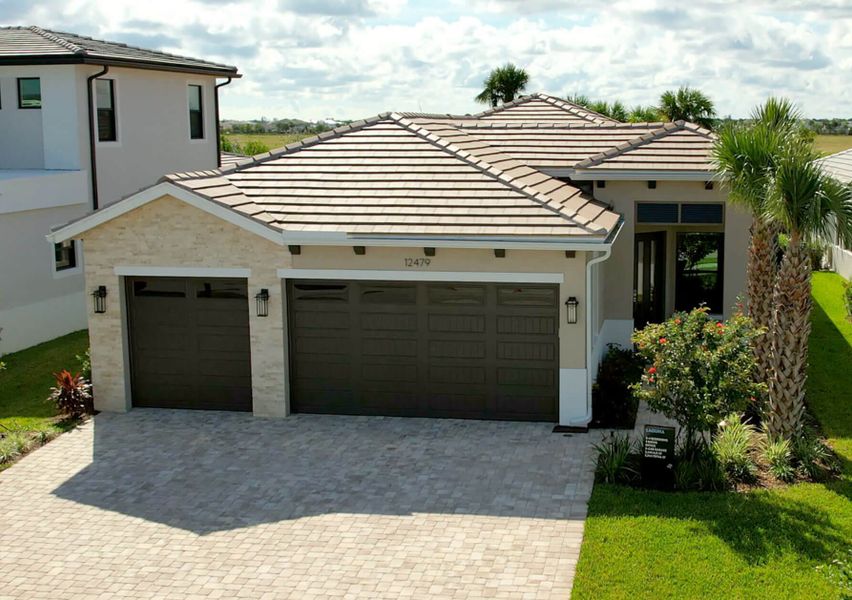 Front exterior of a new home in Solana Bay at Avenir, Palm Beach Gardens, FL, highlighting curb appeal (Image 2).