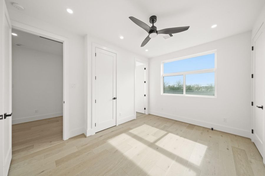 The second bedroom upstairs has an ensuite bath for privacy and access to the laundry room just outside in the hallway.