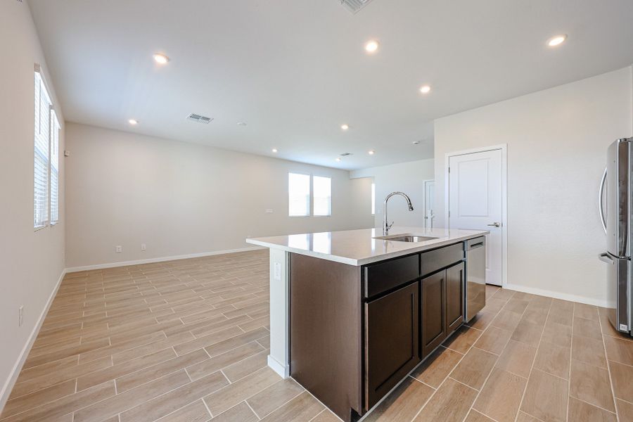 A kitchen with a wood floor.