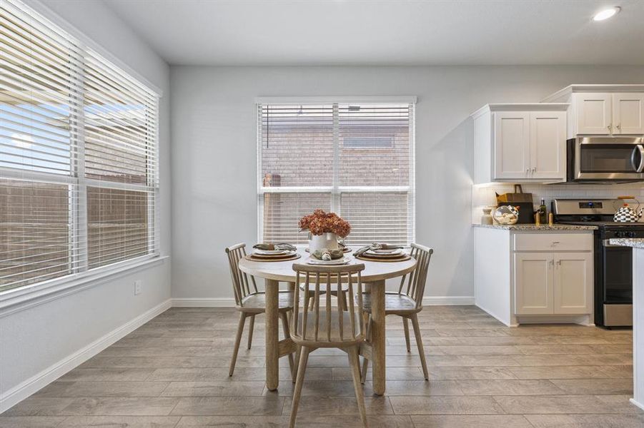 Dining room featuring natural light, windows with blinds. Dining room featuring natural light, windows with blinds.
