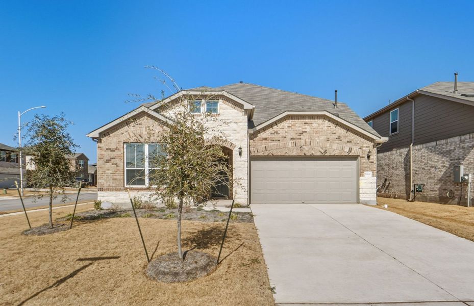 Front exterior of a new home in Lagos, Manor, TX, highlighting curb appeal (Image 20).