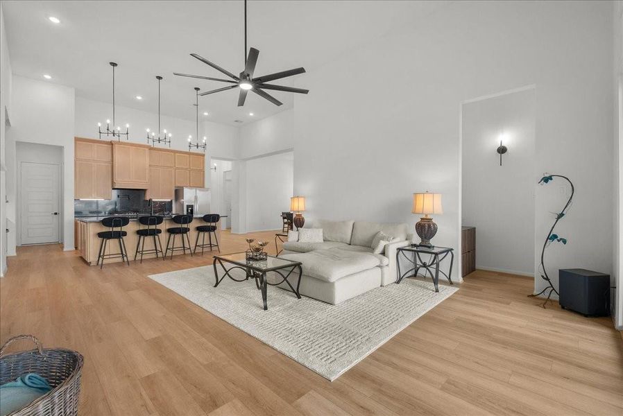 Living room showcases soaring ceilings, a cozy fireplace, and breathtaking water views.