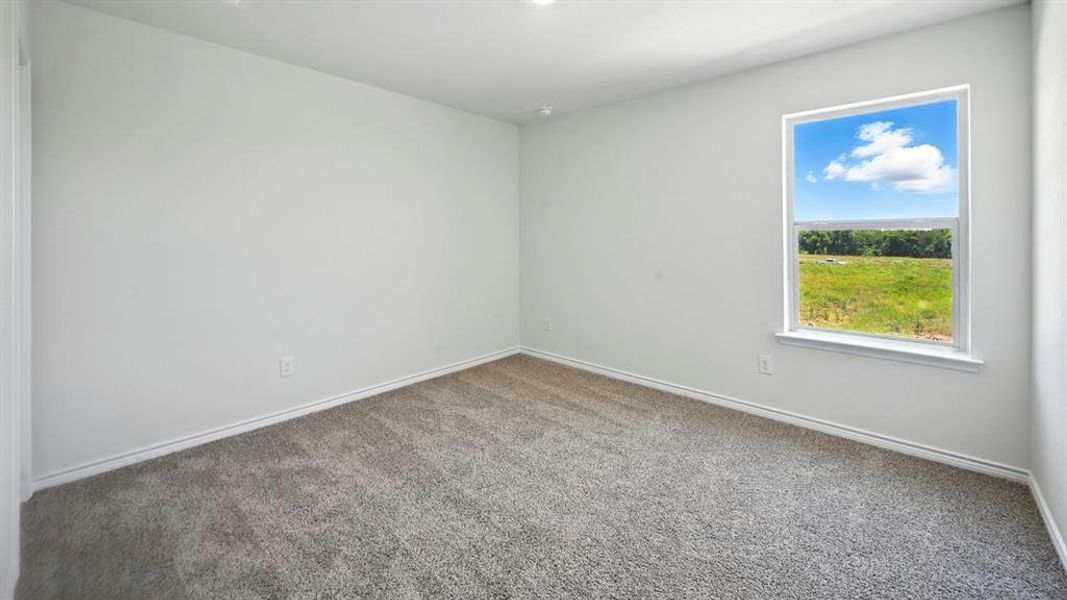 Spare room with baseboards and carpet floors