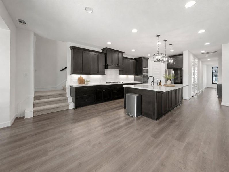 Culinary excellence awaits in this open-concept kitchen with a large island and ample counter space. Culinary excellence awaits in this open-concept kitchen with a large island and ample counter space.