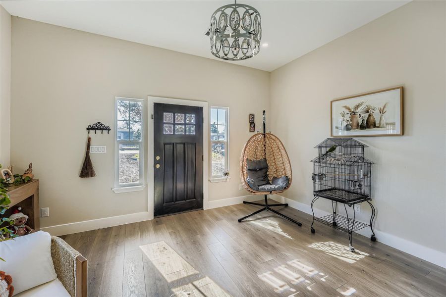 Entrance foyer with hardwood / wood-style floors and a chandelier Entrance foyer with hardwood / wood-style floors and a chandelier