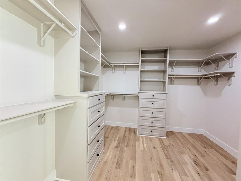 Walk in closet featuring light wood-style floors Walk in closet featuring light wood-style floors
